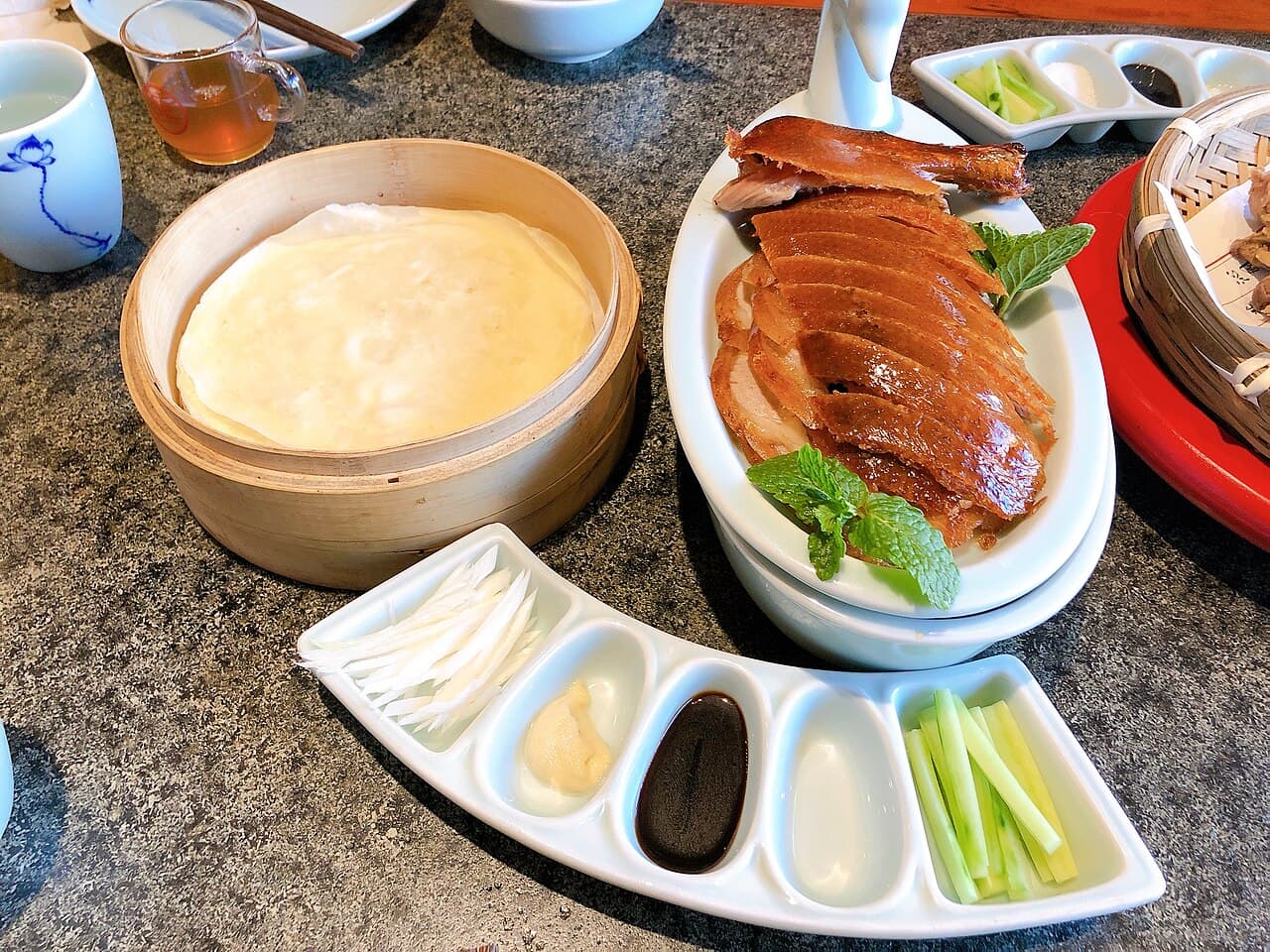 Sliced Peking duck with pancakes, scallions, cucumber and sweet sauce